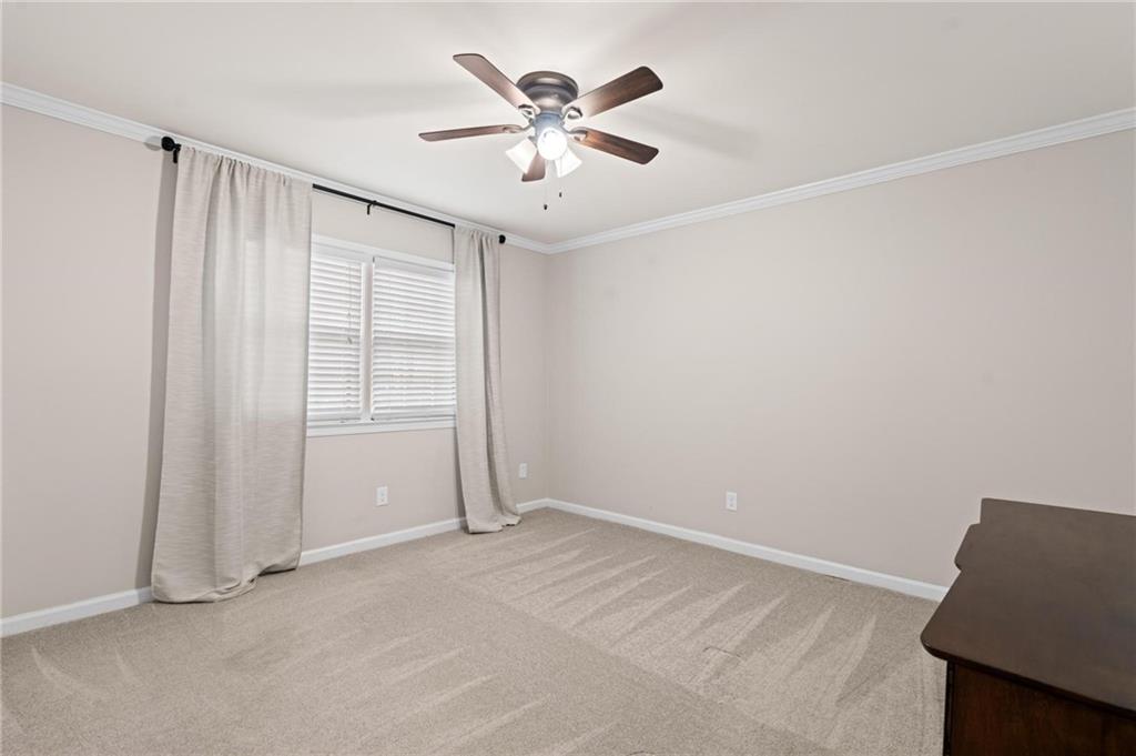 34 Chaumont Square Northwest Atlanta, GA 30327 - Photo 31 of 42 a view of an empty room with a ceiling fan and a window