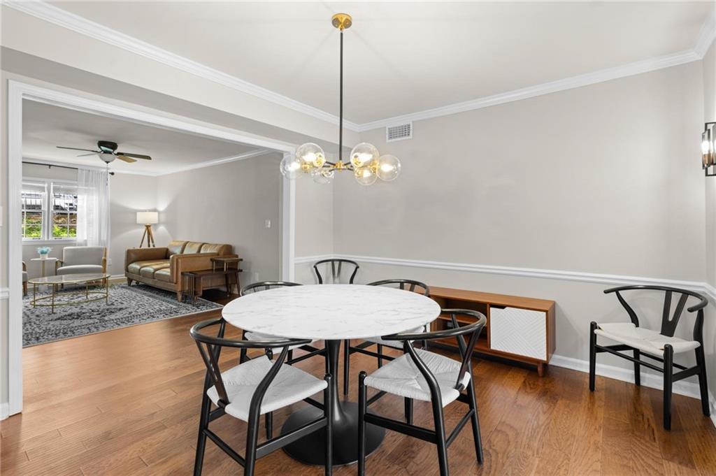 34 Chaumont Square Northwest Atlanta, GA 30327 - Photo 8 of 42 a view of a dining room with furniture and wooden floor