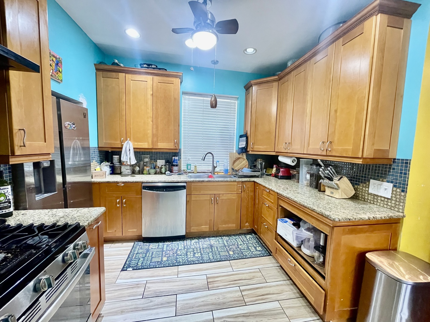 7916 South Constance Avenue Chicago, IL 60617 - Photo 13 of 28 a kitchen with stainless steel appliances granite countertop a stove a sink and a microwave