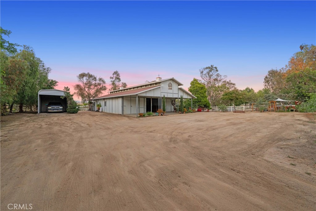 39817 Calle Cabernet Temecula, CA 92591 - Photo 36 of 75 a front view of a house with a yard and a garage