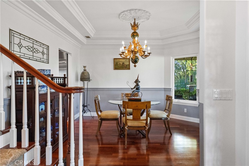 39817 Calle Cabernet Temecula, CA 92591 - Photo 48 of 75 a view of a dining room with furniture a chandelier and wooden floor