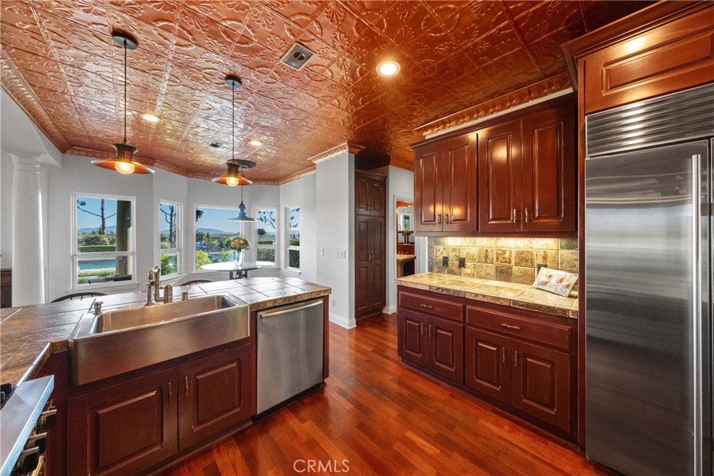 39817 Calle Cabernet Temecula, CA 92591 - Photo 53 of 75 a kitchen with stainless steel appliances granite countertop a sink a stove and a refrigerator