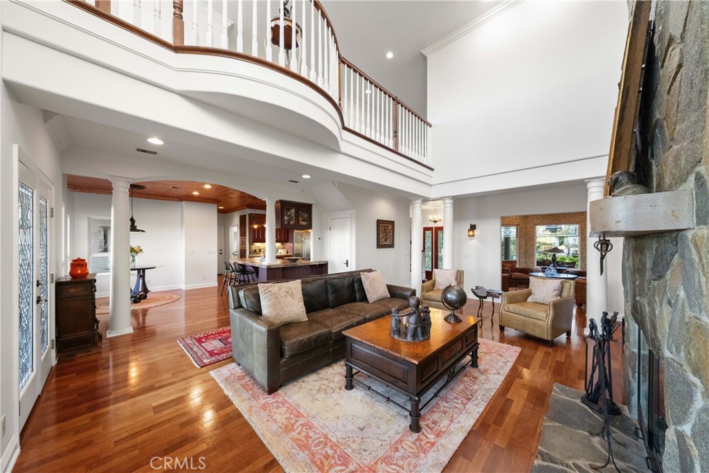 39817 Calle Cabernet Temecula, CA 92591 - Photo 59 of 75 a living room with furniture a fireplace and a chandelier
