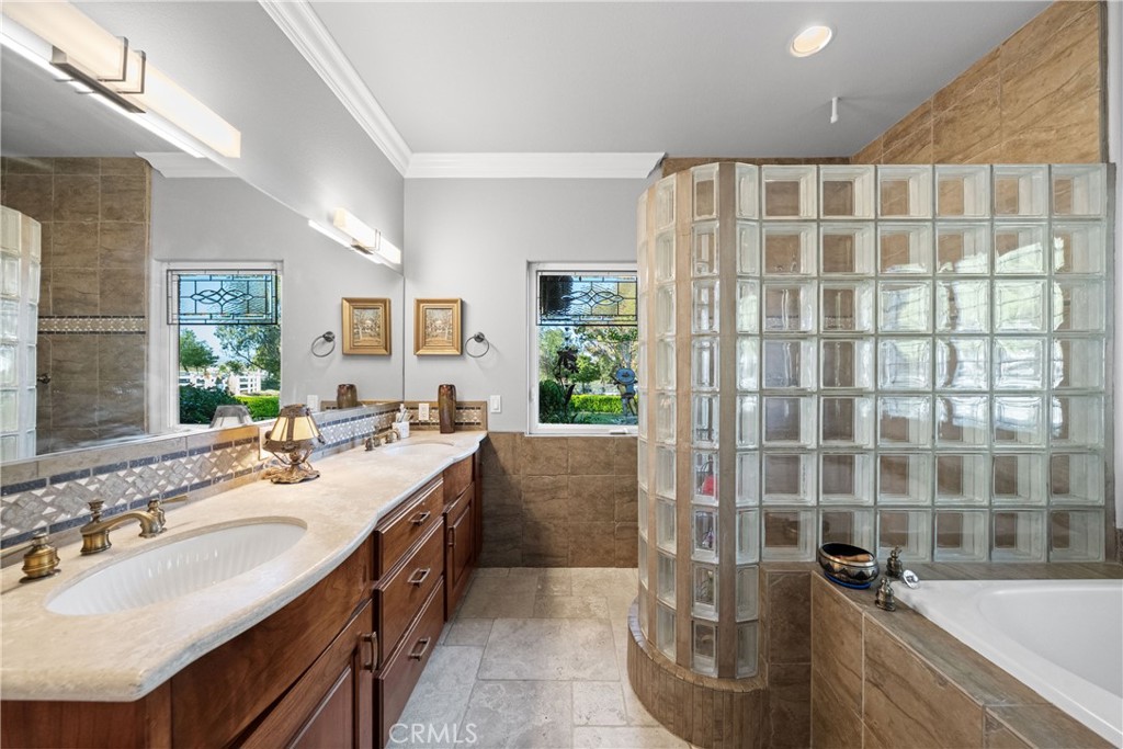 39817 Calle Cabernet Temecula, CA 92591 - Photo 65 of 75 a spacious bathroom with a double vanity sink a mirror a shower and a bathtub