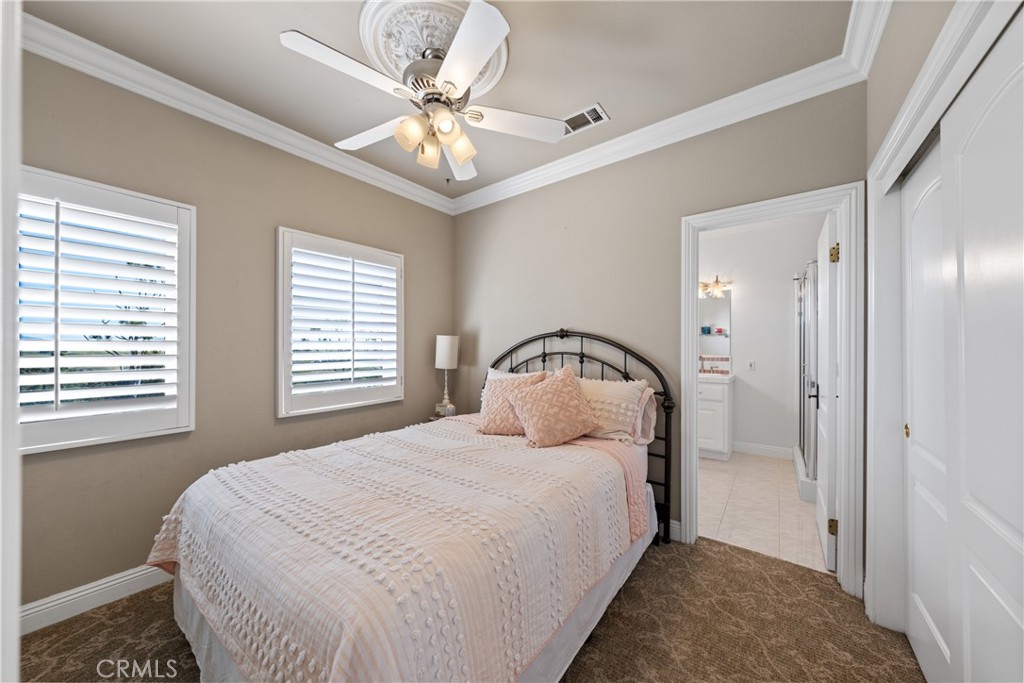 39817 Calle Cabernet Temecula, CA 92591 - Photo 70 of 75 a bedroom with a bed and a chandelier