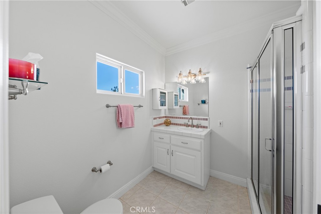 39817 Calle Cabernet Temecula, CA 92591 - Photo 72 of 75 a bathroom with a sink a mirror and a toilet