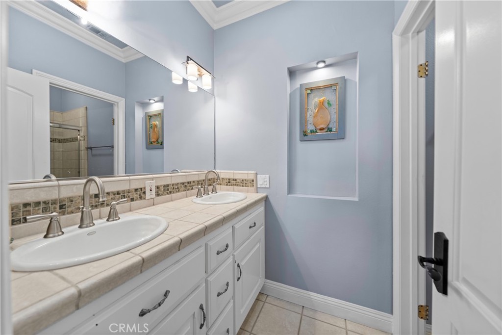 39817 Calle Cabernet Temecula, CA 92591 - Photo 74 of 75 a bathroom with a double vanity sink and a mirror