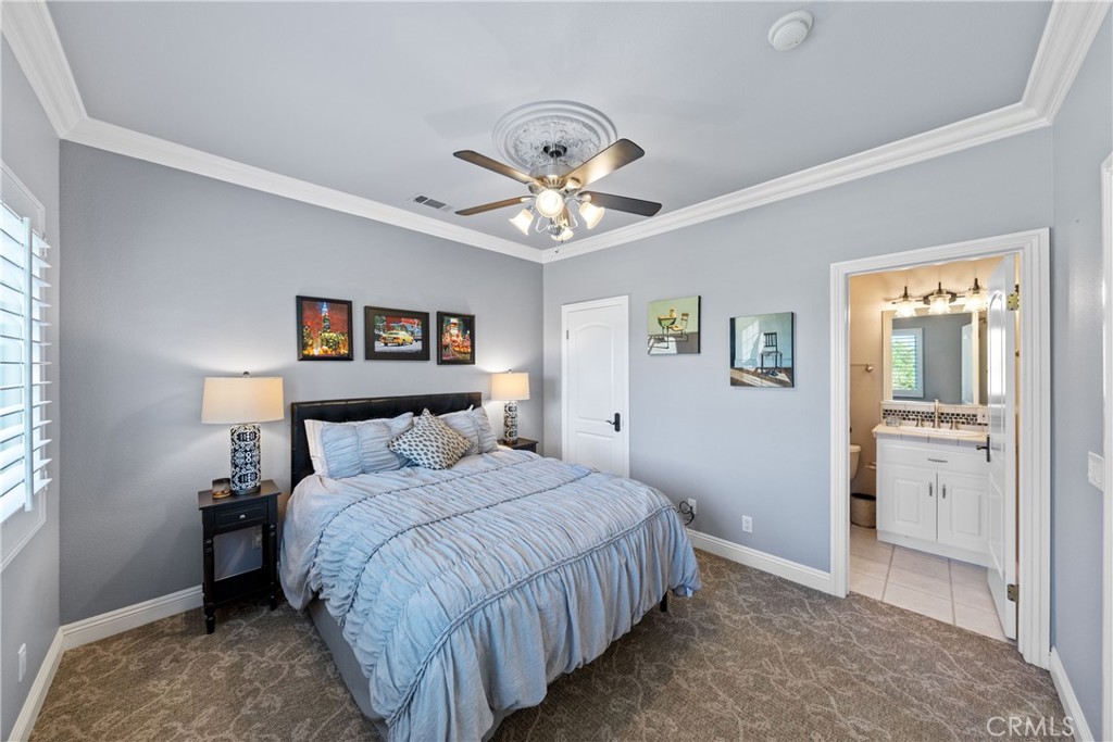 39817 Calle Cabernet Temecula, CA 92591 - Photo 75 of 75 a bedroom with a bed and a chandelier