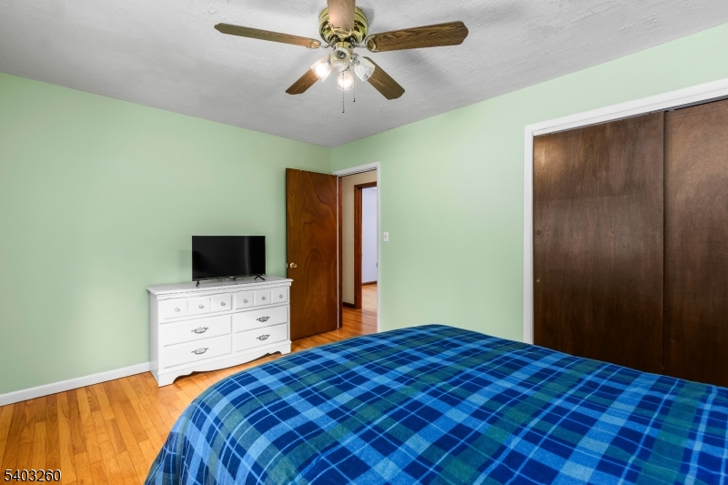 9 Wehrli Road Long Valley, NJ 07853 - Photo 16 of 35 a bedroom with a bed and a flat tv screen on dresser