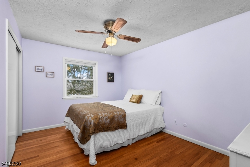 9 Wehrli Road Long Valley, NJ 07853 - Photo 17 of 35 a bedroom with a bed and a chandelier