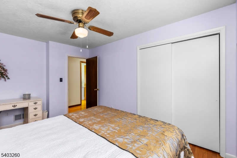 9 Wehrli Road Long Valley, NJ 07853 - Photo 18 of 35 a bedroom with a bed and a chandelier