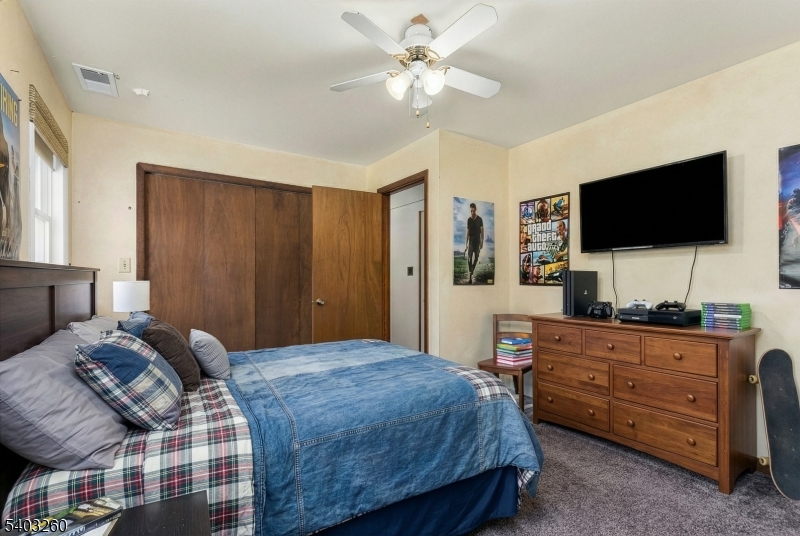 9 Wehrli Road Long Valley, NJ 07853 - Photo 32 of 35 a bedroom with a bed and a flat screen tv