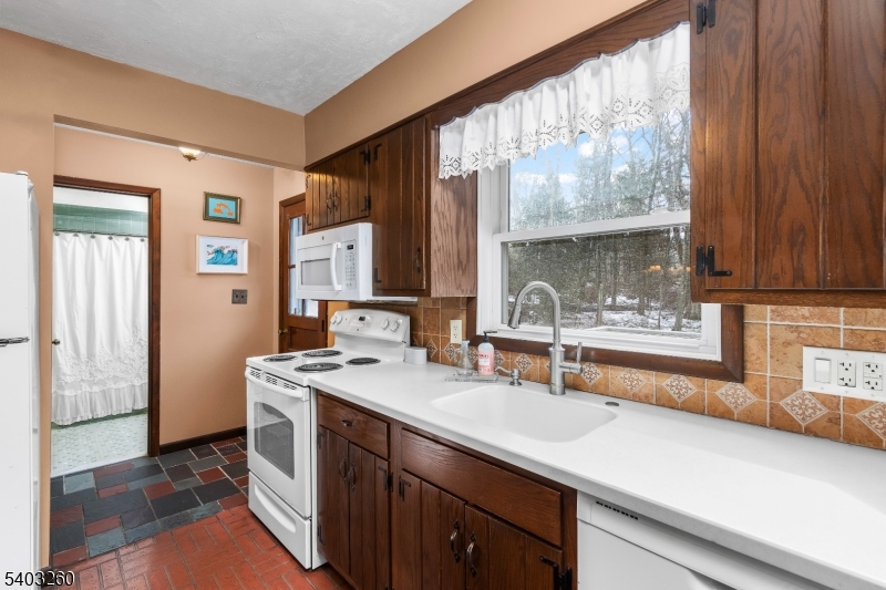 9 Wehrli Road Long Valley, NJ 07853 - Photo 9 of 35 a kitchen with a sink and a refrigerator