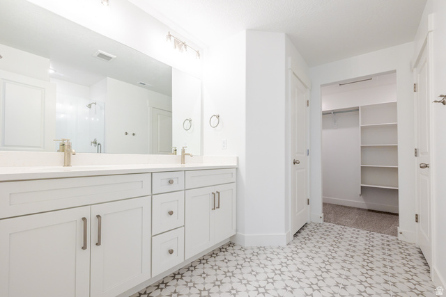 4741 Olive Avenue, Unit 406 Mapleton, UT 84664 - Photo 12 of 20 Bathroom featuring double vanity, a shower stall, a walk in closet, and light floors