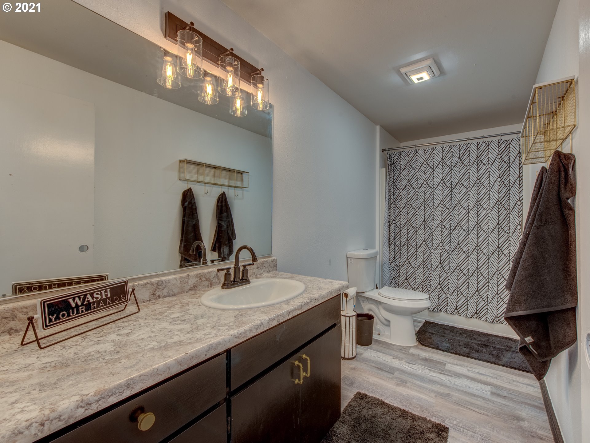 580 54th Street Springfield, OR 97478 - Photo 23 of 31 a bathroom with a sink a toilet and a mirror