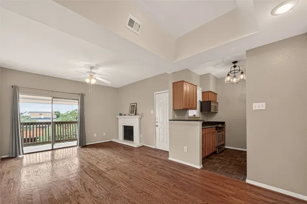 a kitchen with a refrigerator and a stove top oven