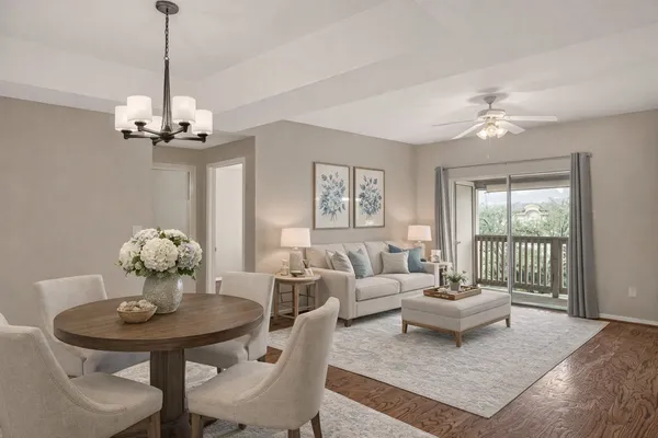 a living room with furniture a chandelier and a window