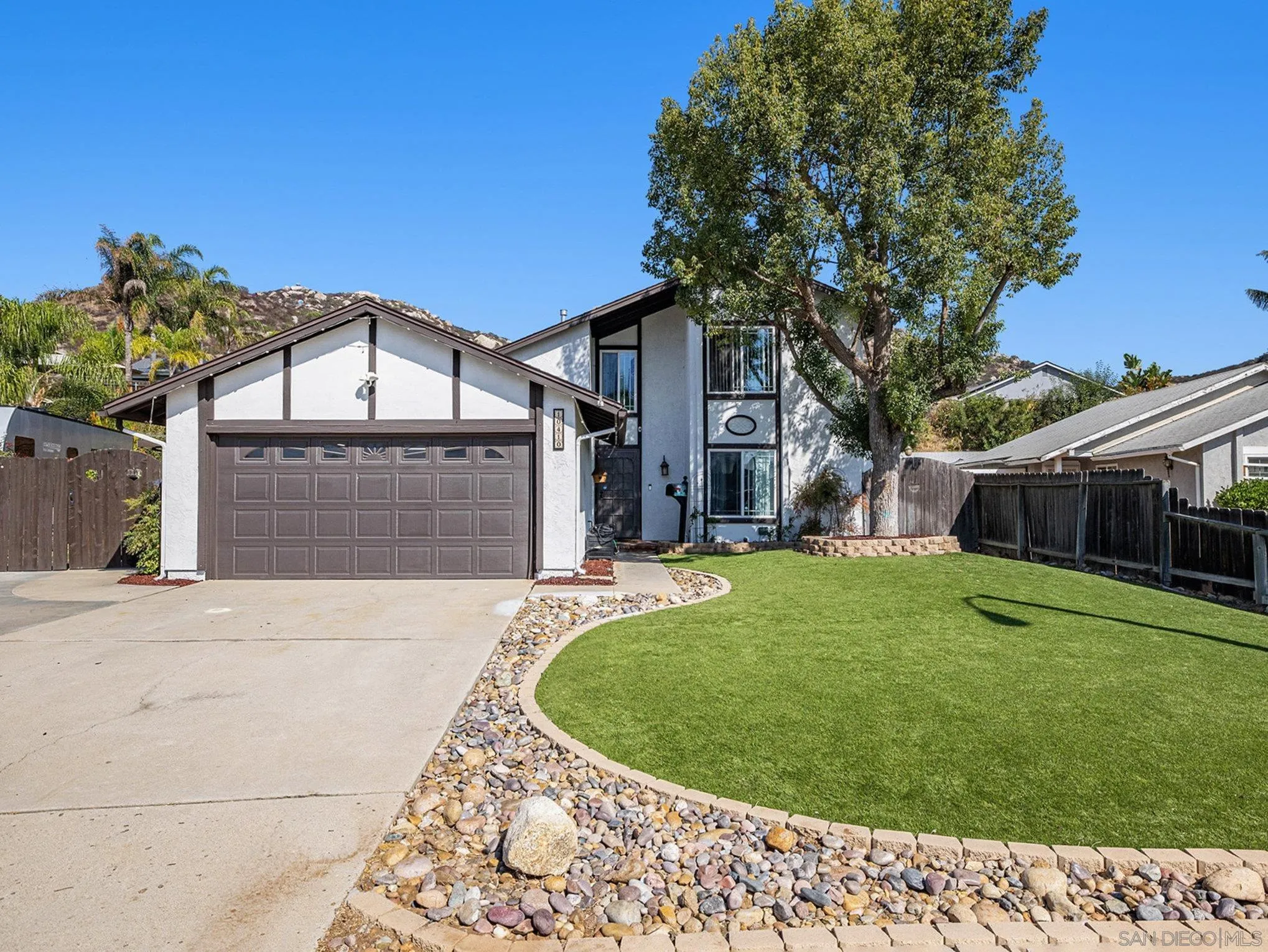 10410 Bosque Drive Lakeside, CA 92040 - Photo 19 of 25 a view of a house with a small yard and a large tree