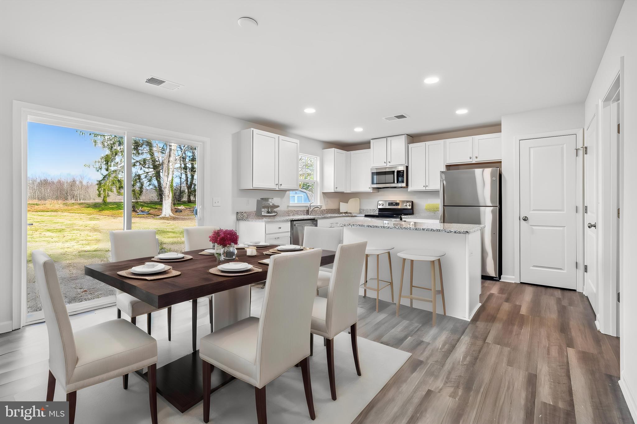 11235 Lord Baltimore Drive Issue, MD 20645 - Photo 21 of 23 a kitchen with a table chairs refrigerator and window