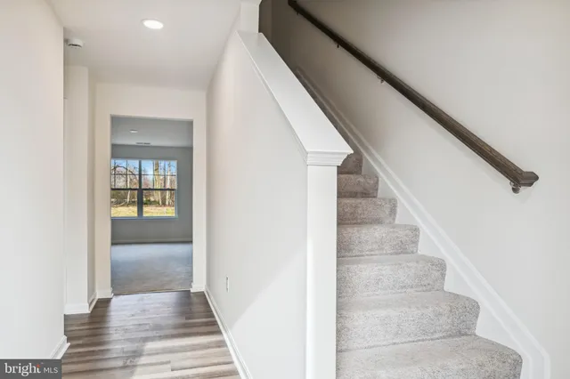 a view of staircase with white walls and windows