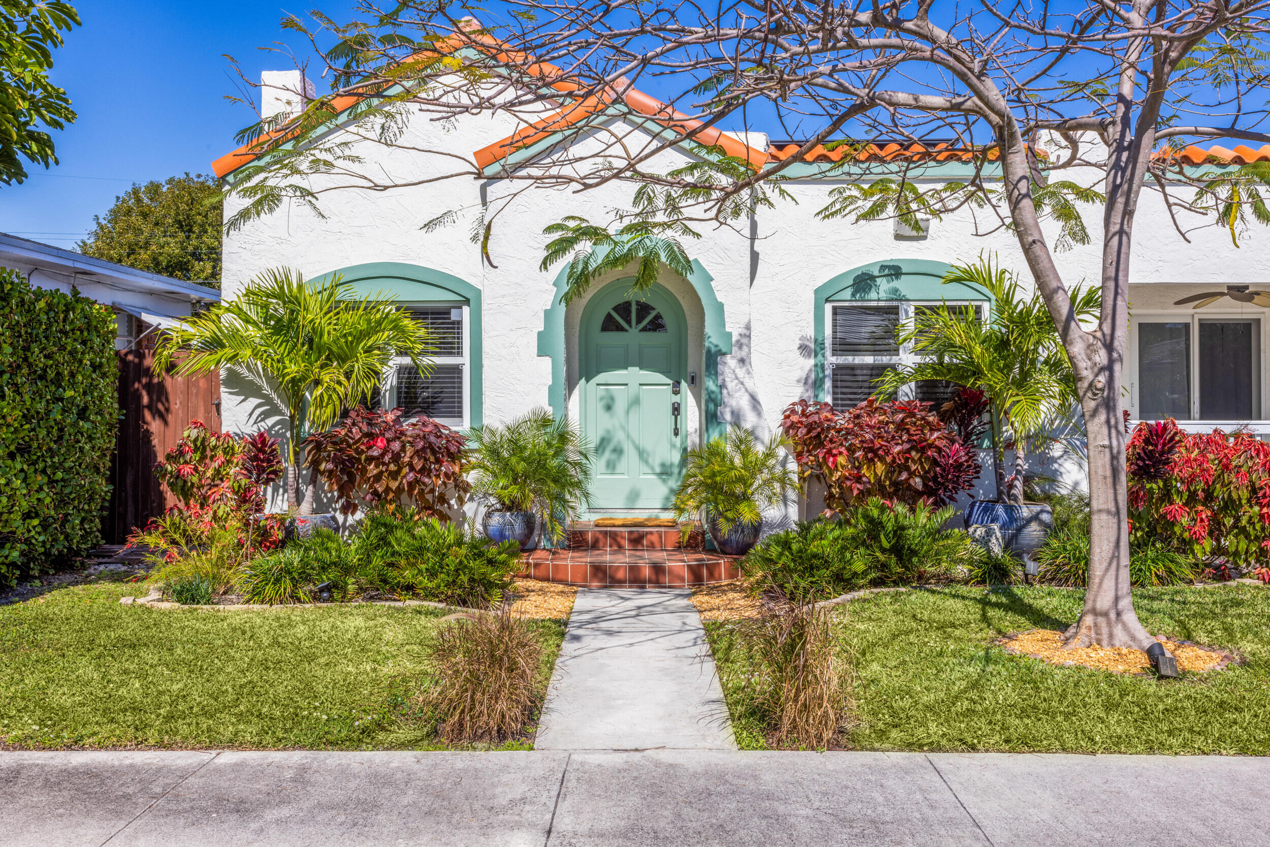 164 Yale Drive Lake Worth Beach, FL 33460 - Photo 1 of 16 a front view of a house with a garden