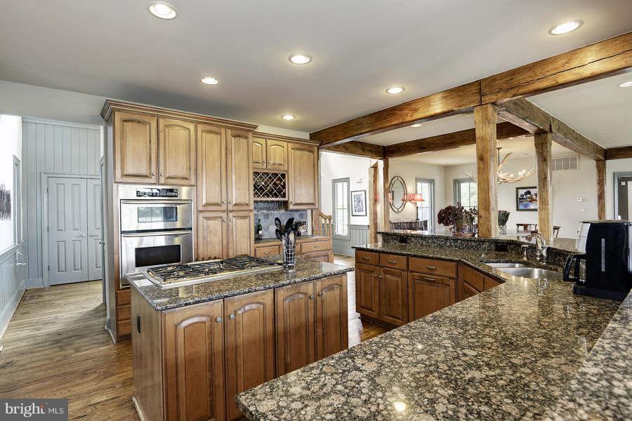 14527 Partnership Road Poolesville, MD 20837 - Photo 14 of 30 a kitchen with stainless steel appliances granite countertop a sink stove and refrigerator