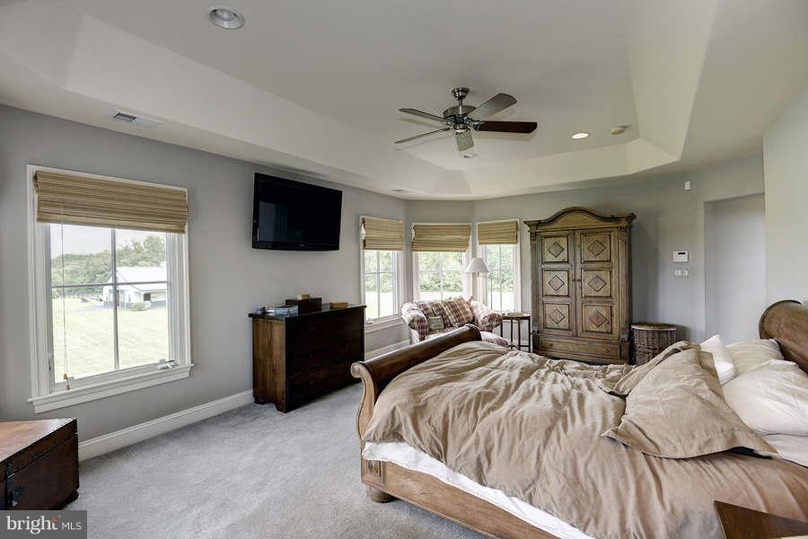 14527 Partnership Road Poolesville, MD 20837 - Photo 19 of 30 a bedroom with a bed and a flat screen tv