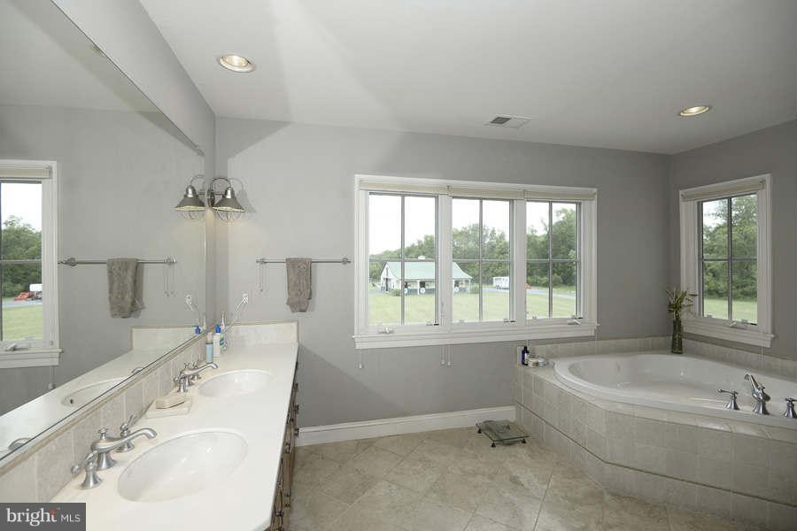 14527 Partnership Road Poolesville, MD 20837 - Photo 21 of 30 a bathroom with a tub sink and mirror