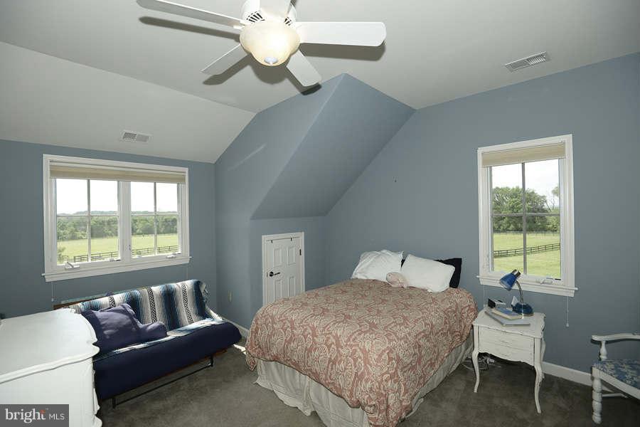 14527 Partnership Road Poolesville, MD 20837 - Photo 23 of 30 a bedroom with a bed and a chandelier