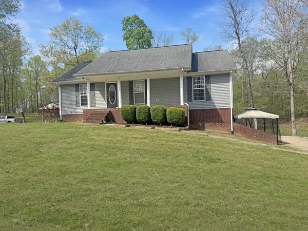 a front view of a house with a garden and porch
