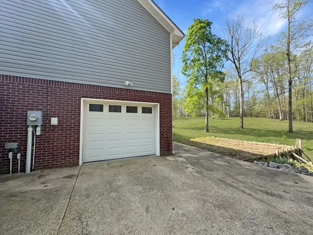 a view of a house with a yard and garage