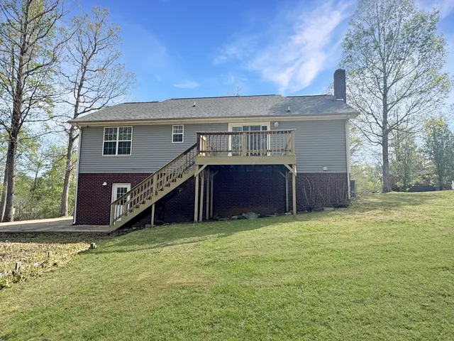 a view of a house with a yard and wooden fence