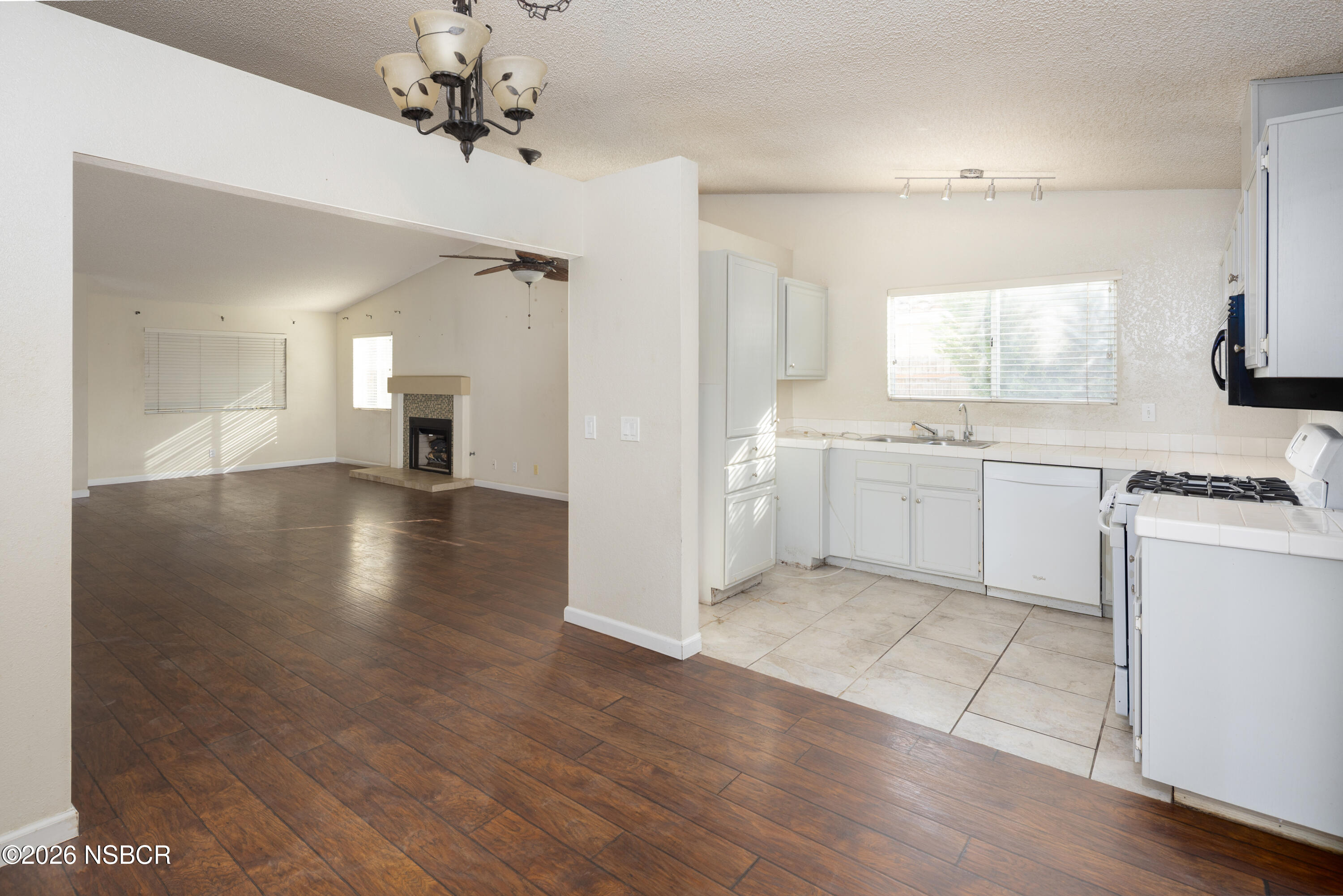 545 Santa Cruz Court Santa Maria, CA 93455 - Photo 11 of 28 a view of a kitchen with a sink a stove top oven and cabinets