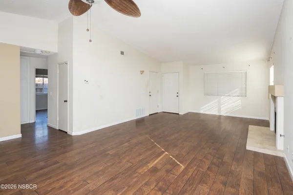 a view of empty room with wooden floor