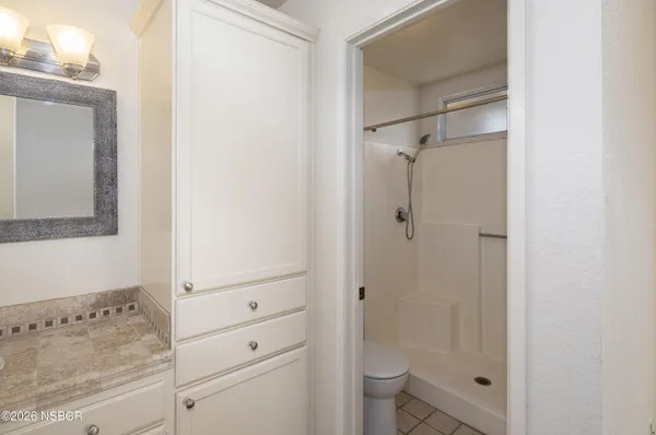 a bathroom with a shower toilet and sink