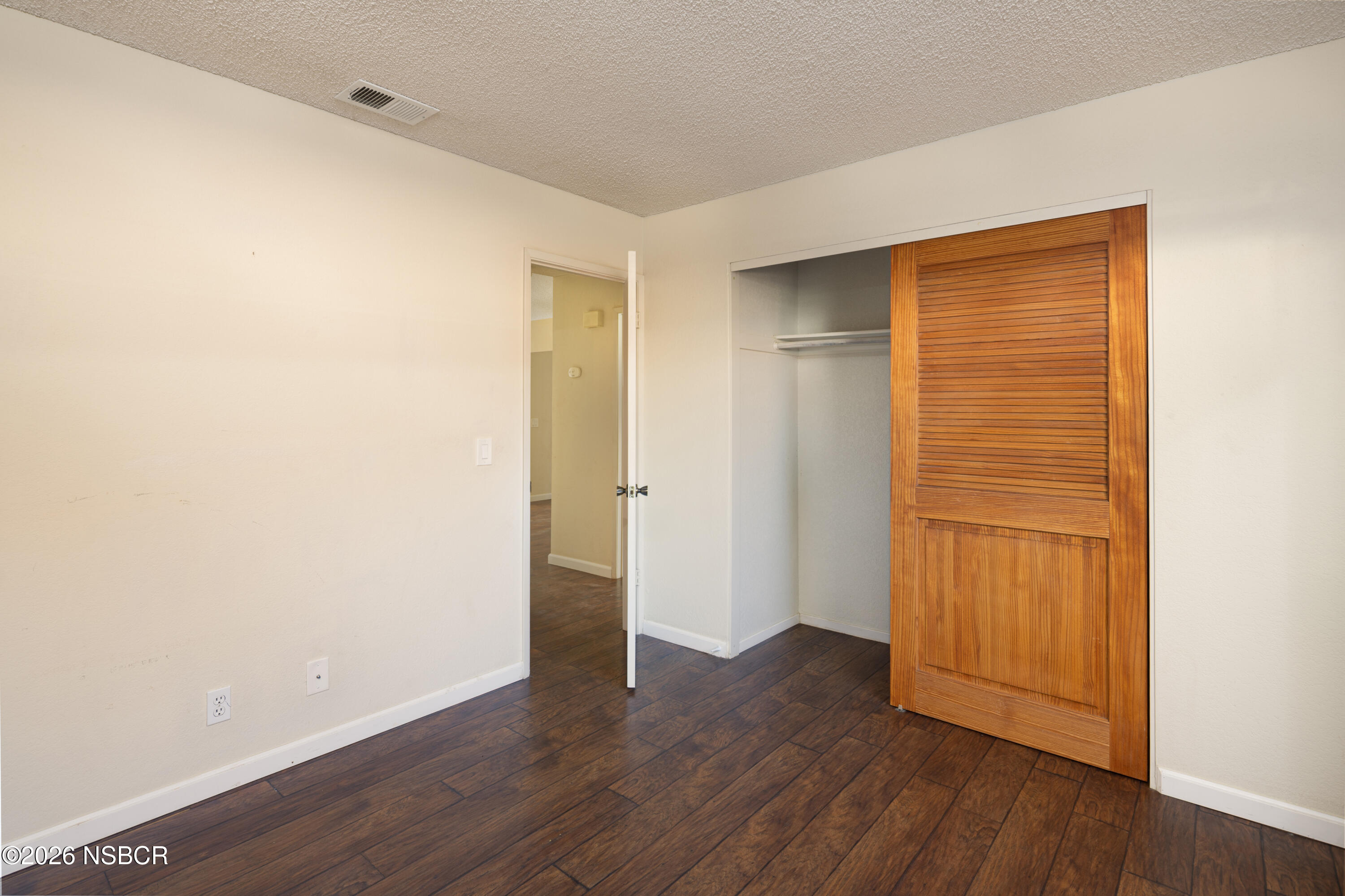 545 Santa Cruz Court Santa Maria, CA 93455 - Photo 22 of 28 a view of an empty room with wooden floor