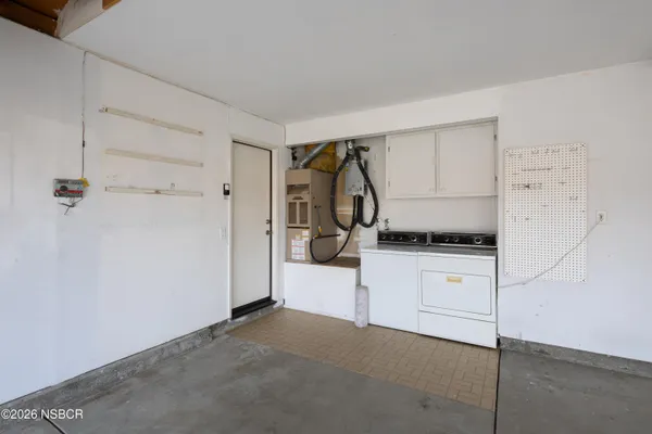 a kitchen with a refrigerator and white cabinets