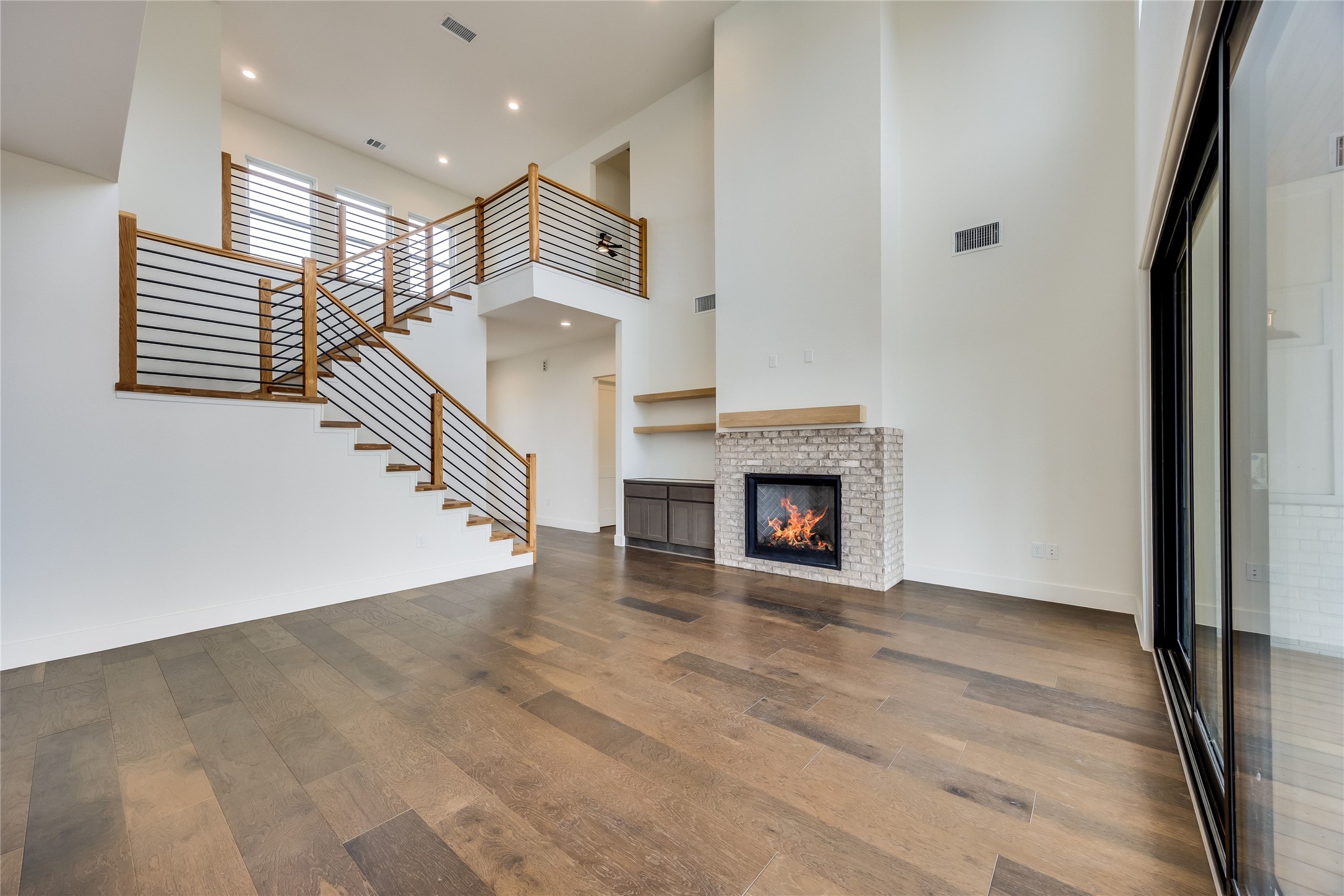 288 Smoke Tree Circle Dripping Springs, TX 78620 - Photo 5 of 40 a view of a livingroom with wooden floor and a fireplace