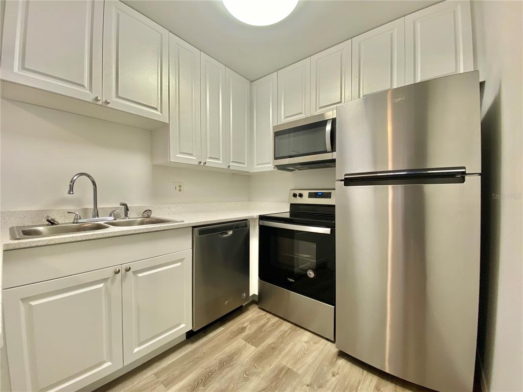 6519 West Newberry Road, Unit 1211 Gainesville, FL 32605 - Photo 7 of 10 a kitchen with cabinets and stainless steel appliances
