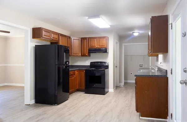a kitchen with stainless steel appliances granite countertop a refrigerator stove and sink