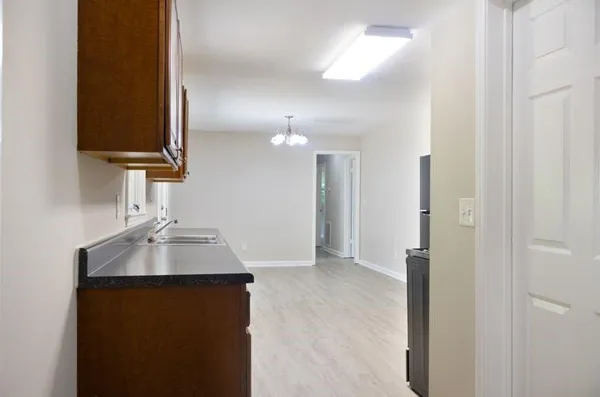 a kitchen with a sink and a mirror