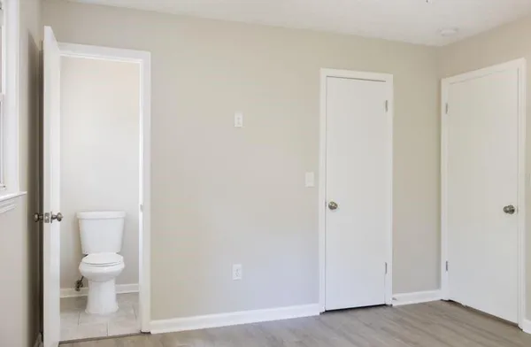 a white toilet sitting next to a bathroom sink