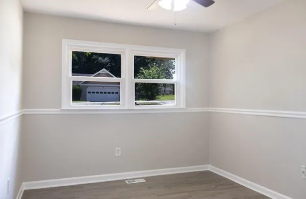 a view of a small space with wooden floor and balcony