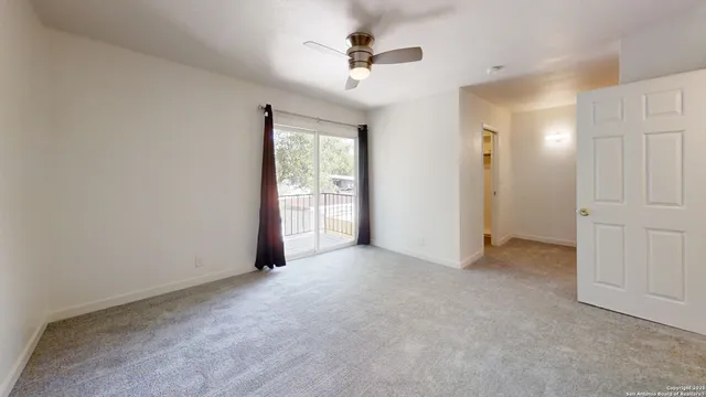 an empty room with fan and a ceiling fan