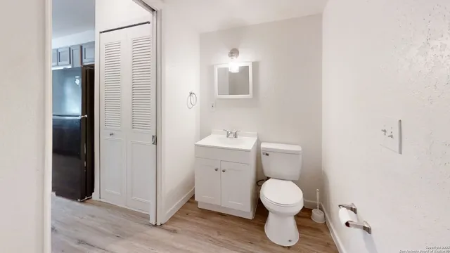 a bathroom with a toilet sink and mirror