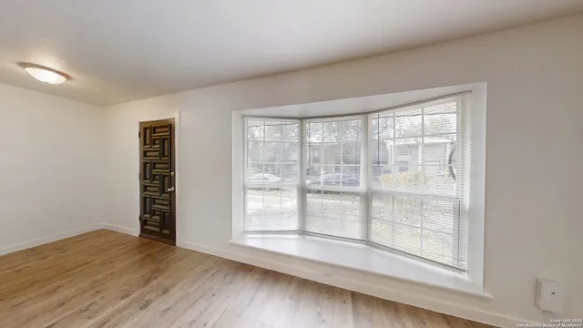 a view of wooden floor and windows in a room