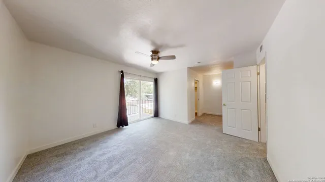 an empty room with closet and windows