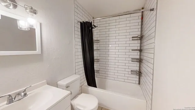 a bathroom with a shower curtain and a sink
