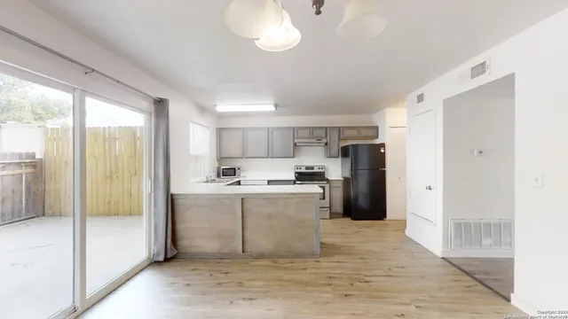 a kitchen with stainless steel appliances granite countertop a refrigerator and a sink