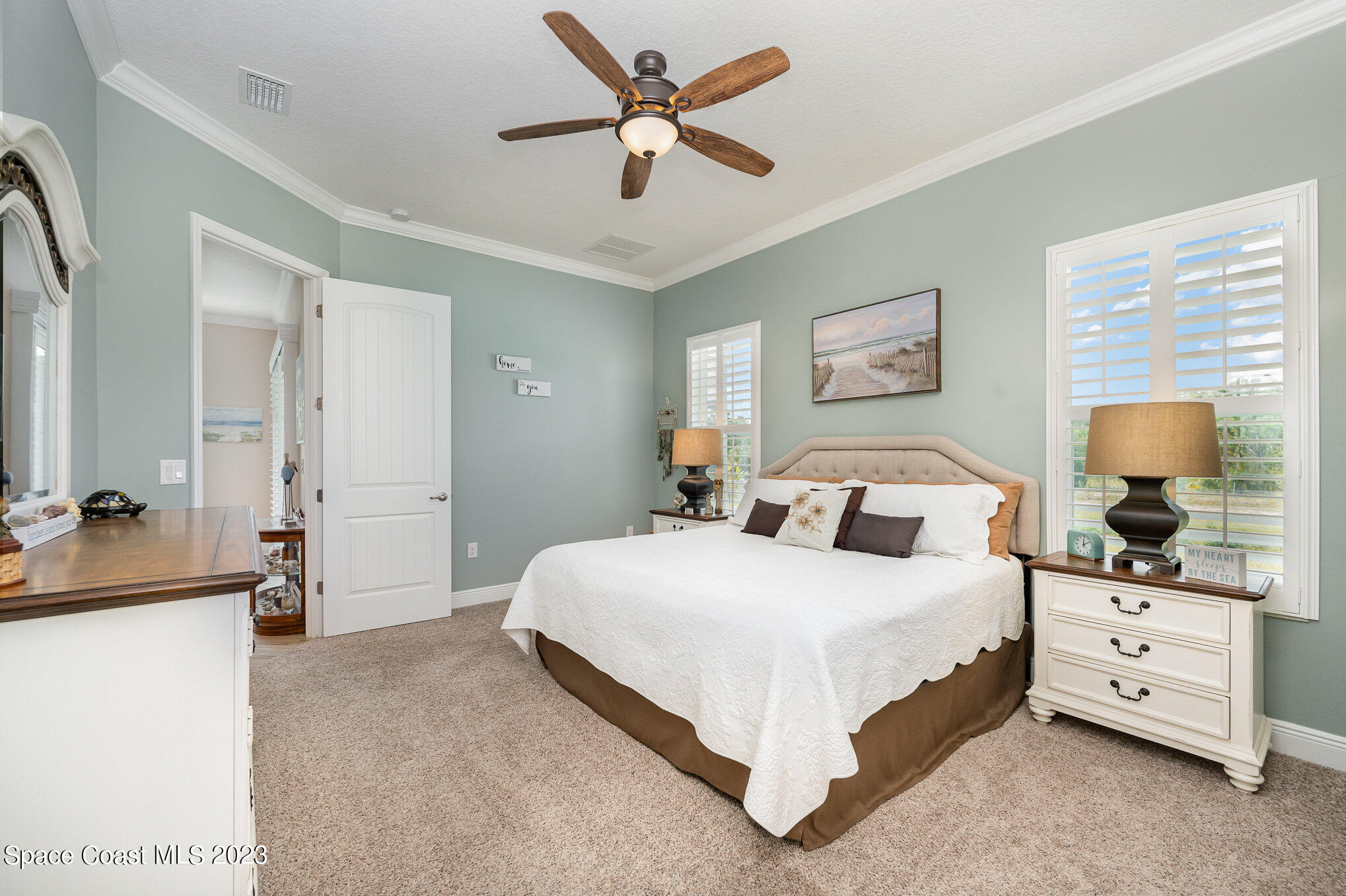 3850 Alamanda Key Drive Melbourne, FL 32901 - Photo 10 of 44 a bedroom with a bed and a chandelier